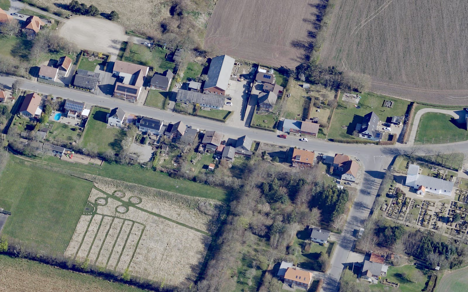 Landevej gennem Lydum med huse, marker og kirkegård ved ådalen